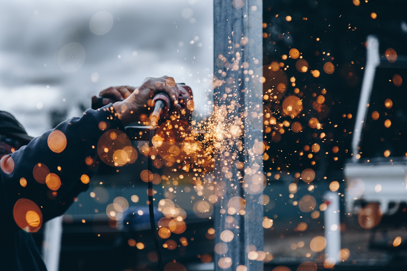 Close-up of precision metalwork with sparks — engineering craft